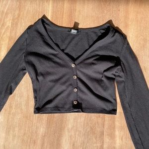 Black long sleeve cropped shirt.